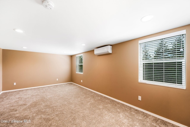 carpeted spare room with an AC wall unit and plenty of natural light