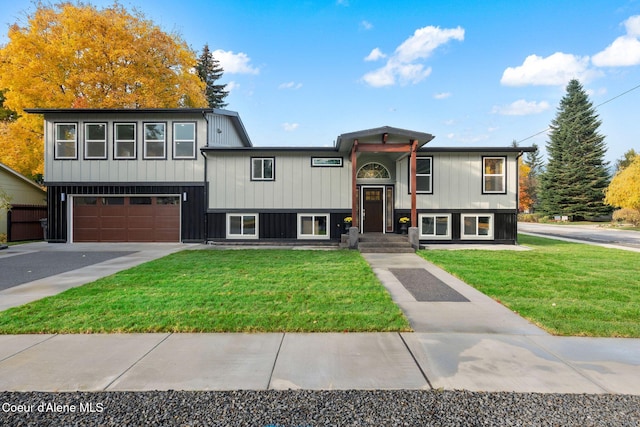 bi-level home with a garage and a front yard