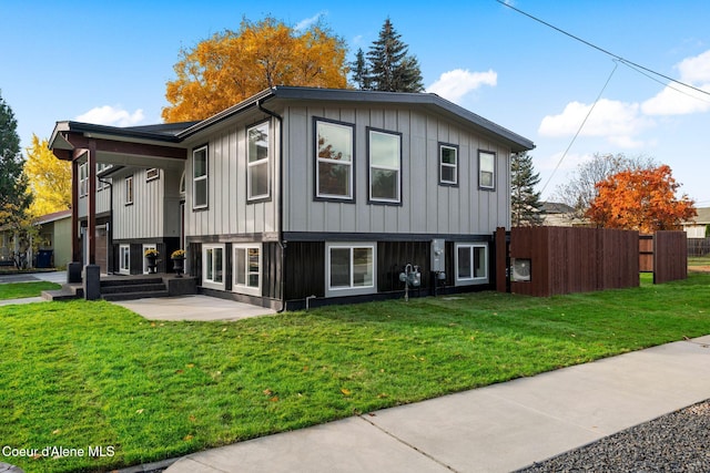 view of property exterior with a patio and a lawn