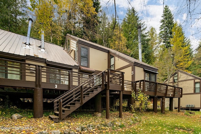 rear view of property featuring a wooden deck