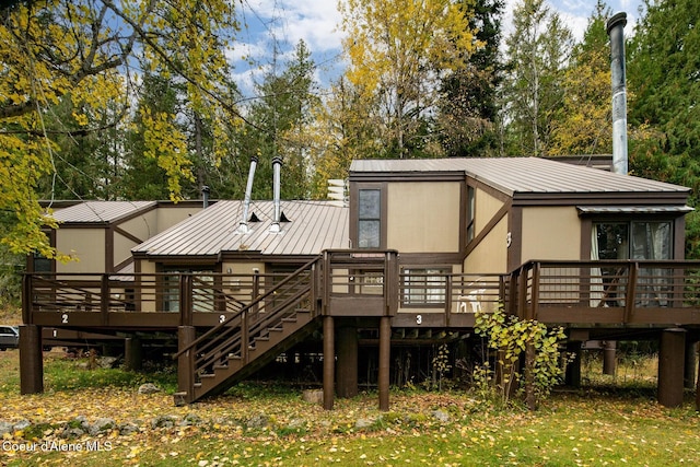 rear view of property featuring a deck