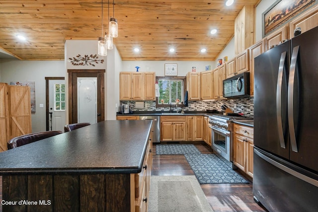 kitchen with black appliances, a barn door, a center island, pendant lighting, and dark wood-type flooring