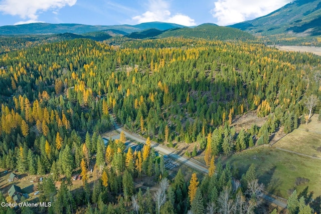 648 Curley Creek Rd, Moyie Springs, ID 83845 - aerial view of property and surrounding area featuring a forest and a mountain backdrop