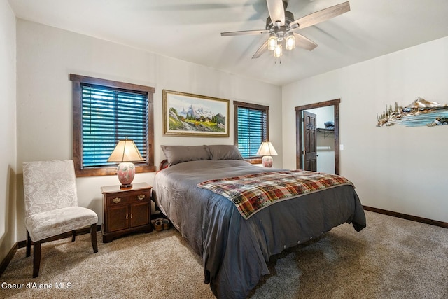 648 Curley Creek Rd, Moyie Springs, ID 83845 - bedroom with light colored carpet, baseboards, a spacious closet, and a ceiling fan