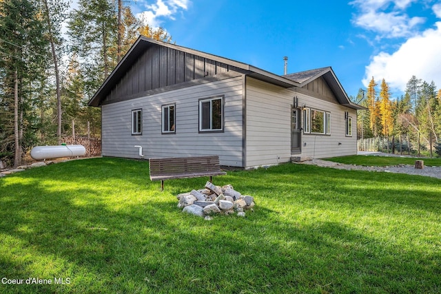 648 Curley Creek Rd, Moyie Springs, ID 83845 - back of property with board and batten siding and a lawn
