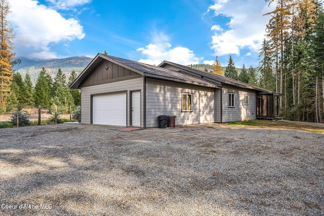 view of home's exterior with a mountain view and a garage