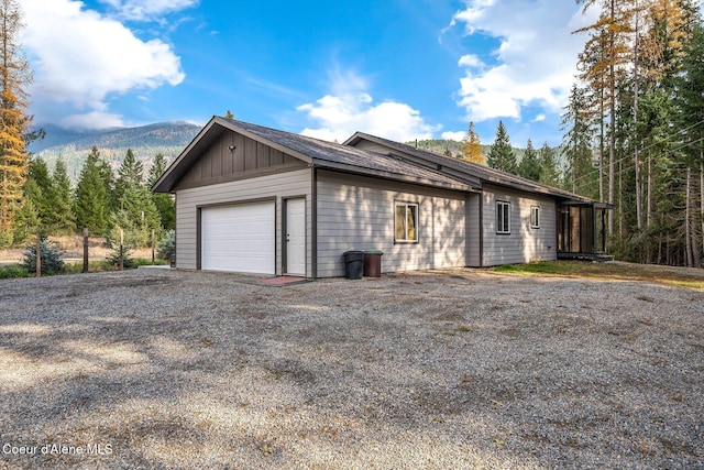 648 Curley Creek Rd, Moyie Springs, ID 83845 - garage featuring gravel driveway and a mountain view