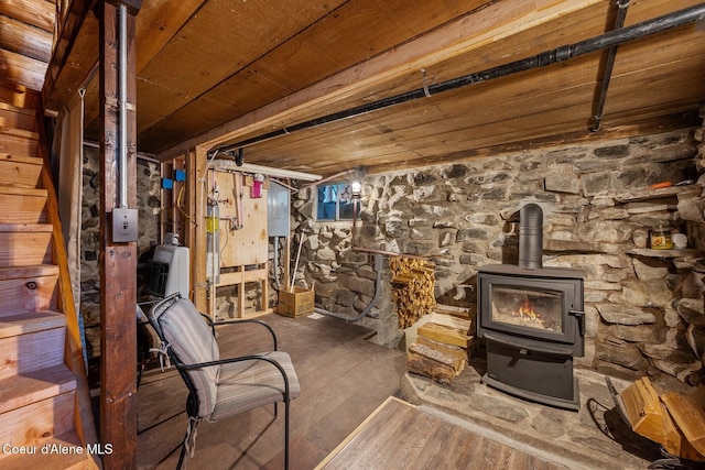 648 Curley Creek Rd, Moyie Springs, ID 83845 - unfinished below grade area featuring a wood stove, wood ceiling, wood finished floors, and stairs