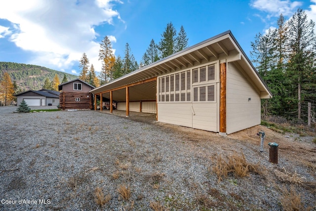 exterior space with a mountain view and an outbuilding