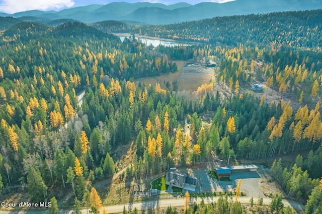 648 Curley Creek Rd, Moyie Springs, ID 83845 - aerial view of property and surrounding area with a mountain backdrop and a heavily wooded area