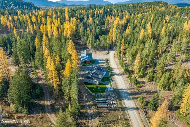 648 Curley Creek Rd, Moyie Springs, ID 83845 - aerial view of property's location with a heavily wooded area and a mountain backdrop