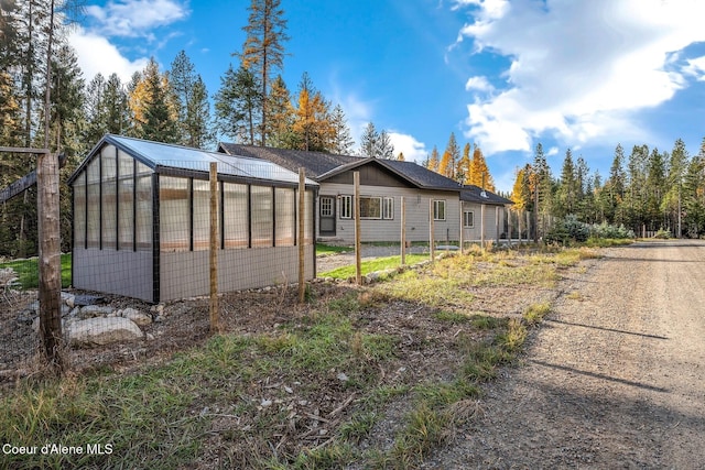 648 Curley Creek Rd, Moyie Springs, ID 83845 - view of side of home featuring a greenhouse and an outbuilding