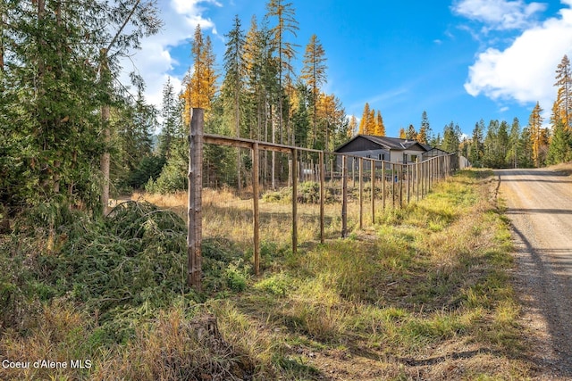 648 Curley Creek Rd, Moyie Springs, ID 83845 - view of yard with fence, a wooded view, and driveway
