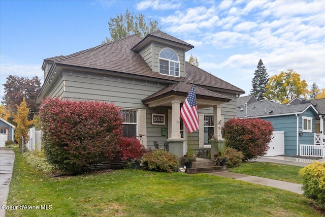 bungalow-style house featuring a front yard and a garage