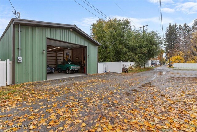view of outbuilding with fence and an outbuilding