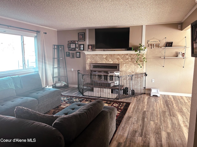 living room featuring crown molding, hardwood / wood-style flooring, and a textured ceiling