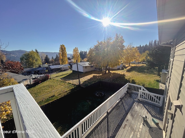 view of yard with a deck with mountain view