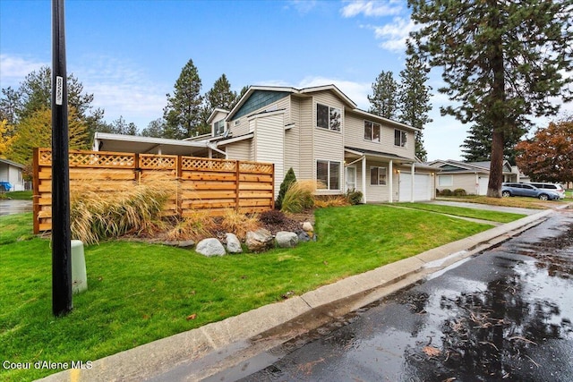 view of front facade with a front yard and a garage