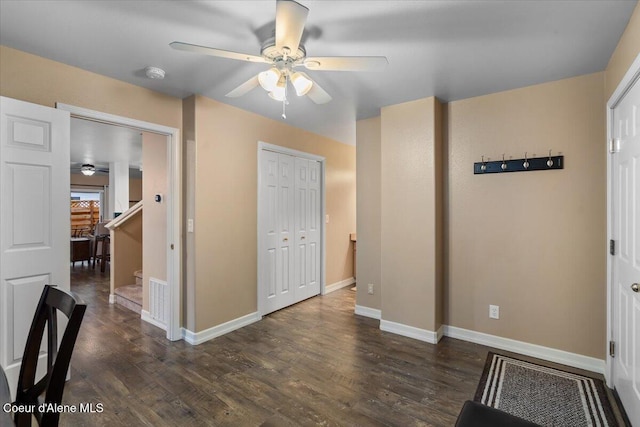 interior space with ceiling fan and dark hardwood / wood-style flooring