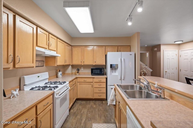 kitchen with light brown cabinets, track lighting, dark wood-type flooring, sink, and white appliances