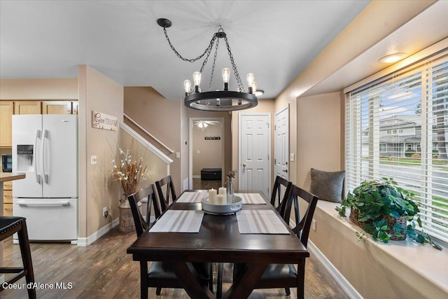 dining area featuring dark hardwood / wood-style floors and an inviting chandelier