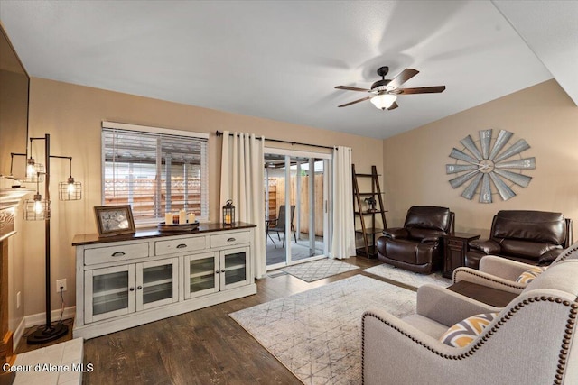 living room with ceiling fan, dark wood-type flooring, and a wealth of natural light