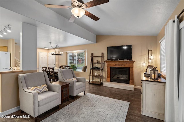 living room featuring lofted ceiling, dark hardwood / wood-style floors, and ceiling fan with notable chandelier