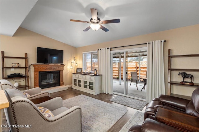 living room featuring lofted ceiling, dark wood-type flooring, and ceiling fan