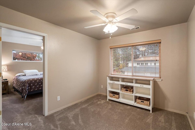 bedroom with dark carpet and ceiling fan