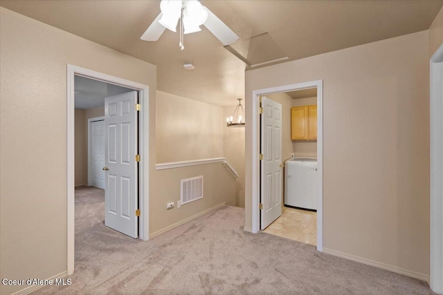 hall featuring light carpet and washer / dryer