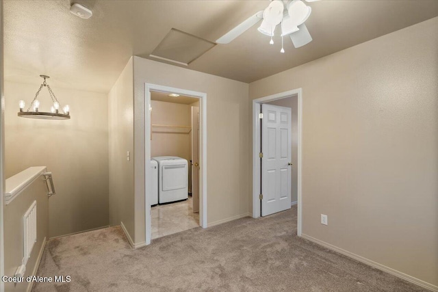 hall featuring washing machine and clothes dryer and light colored carpet