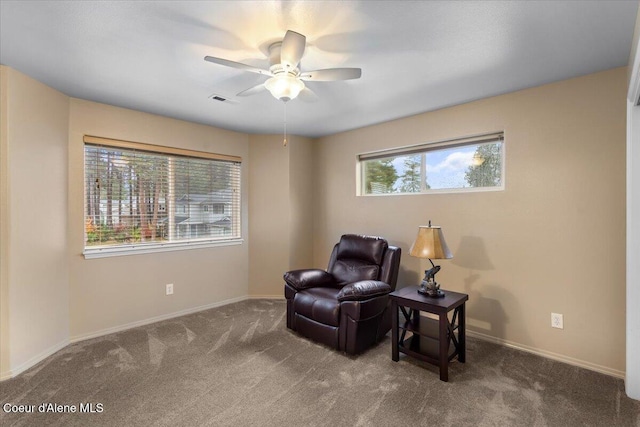 sitting room with ceiling fan, a healthy amount of sunlight, and carpet flooring