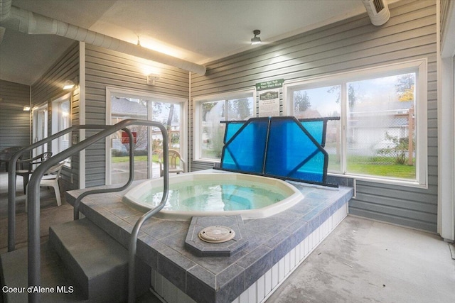 interior space featuring a wealth of natural light and a hot tub