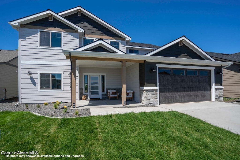 view of front of property with a garage and a front yard