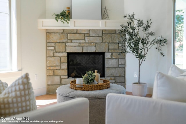 living room featuring a stone fireplace