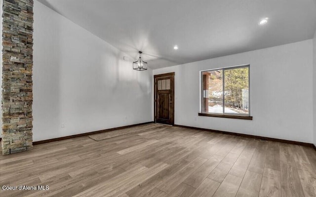 interior space featuring a chandelier and light wood-type flooring