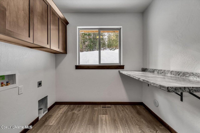 laundry area featuring washer hookup, cabinets, dark hardwood / wood-style floors, and hookup for an electric dryer