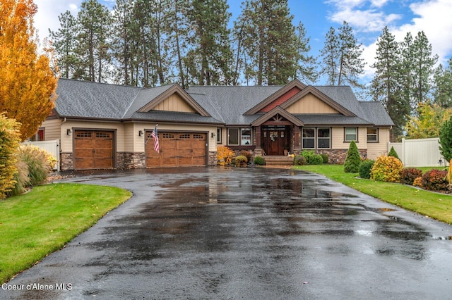 craftsman inspired home with a garage and a front yard