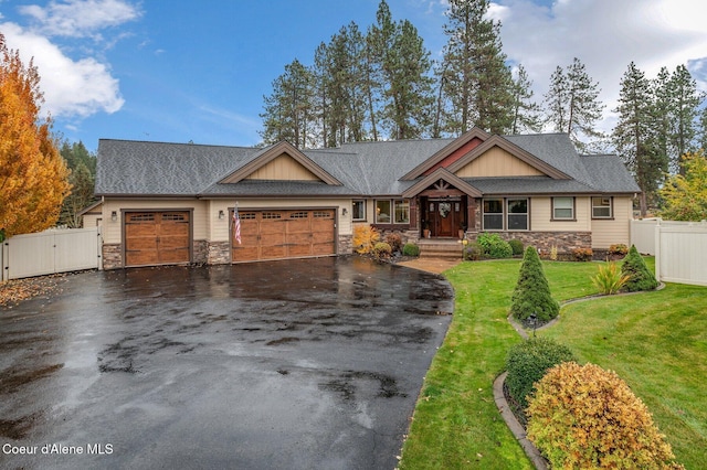 craftsman-style house with a garage and a front lawn