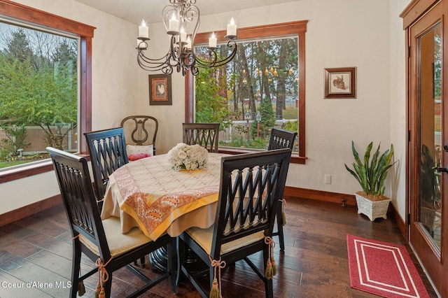 dining area with dark hardwood / wood-style flooring and a chandelier