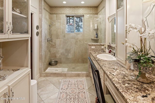 bathroom with vanity, tile patterned floors, and tiled shower