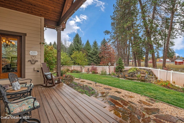 wooden terrace with a lawn