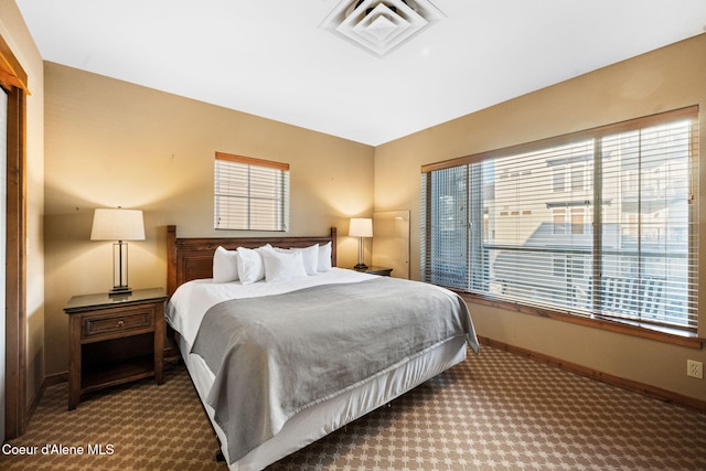 carpeted bedroom with multiple windows