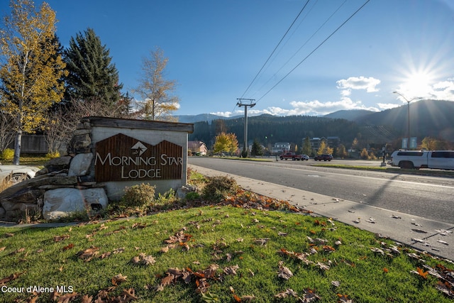 community / neighborhood sign with a mountain view