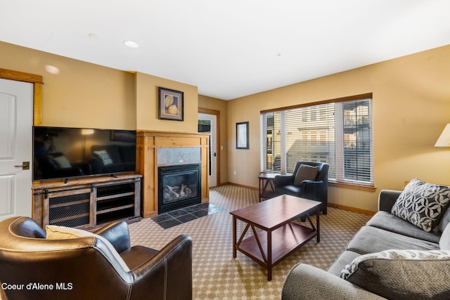 living room with a tile fireplace and carpet floors