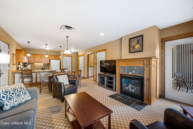 living room with carpet and a fireplace