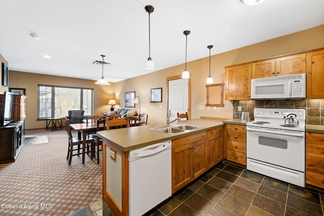 kitchen featuring sink, kitchen peninsula, white appliances, pendant lighting, and decorative backsplash