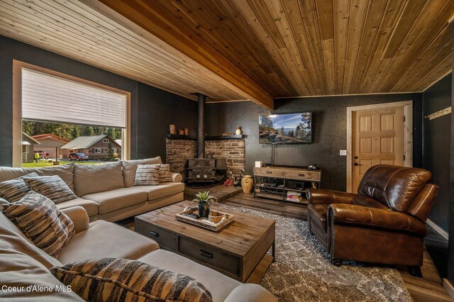 living room featuring a wood stove, dark hardwood / wood-style flooring, and wooden ceiling