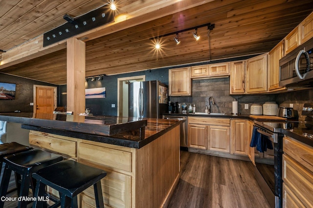 kitchen featuring stainless steel appliances, dark wood-type flooring, wood ceiling, sink, and a kitchen island