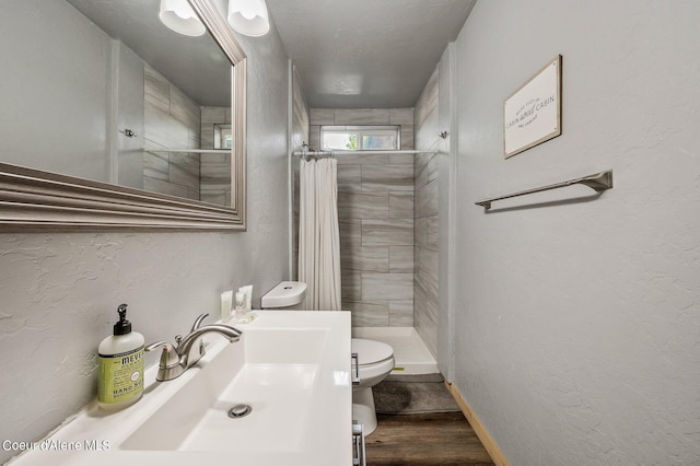 bathroom with toilet, hardwood / wood-style floors, sink, and a shower with shower curtain